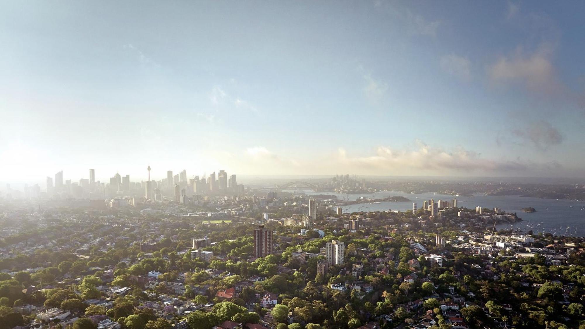 Meriton Suites Bondi Junction Sydney Kültér fotó The photo shows a panoramic view of a city skyline, likely taken from a high vantage point. In the foreground, there are lush green trees and buildings, suggesting a suburban area. As the view extends towards the background, tall skyscrapers dominate